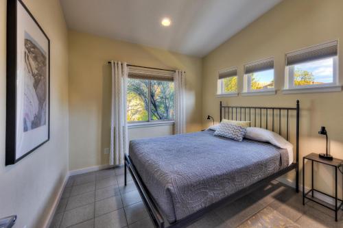 a bedroom with a bed and two windows at The Kayenta Flat in Moab UT in Moab
