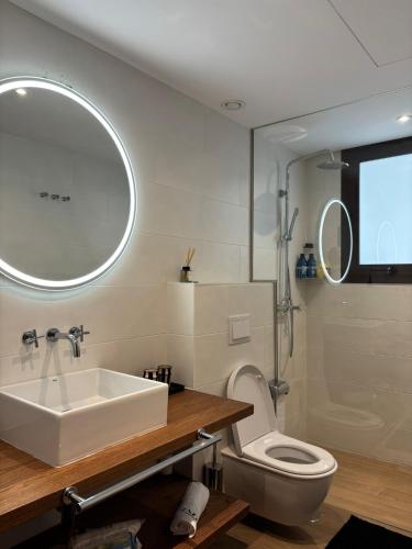 a bathroom with a sink and a toilet and a mirror at Zazz Estepona in Estepona