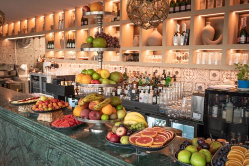 a bar with a bunch of fruits and vegetables at Hayat Hotels & Apartments in Rust