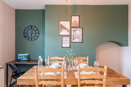 a dining room with a wooden table and chairs at Spacious 3-Bed with parking NEAR NEC & BHX AIRPORT in Allesley