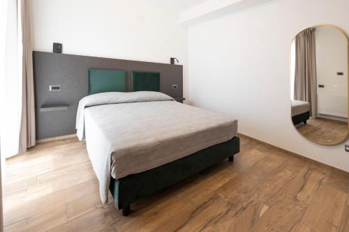 a bedroom with a bed and a large mirror at Terre del Mandrolisai in Sorgono