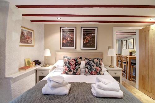a bedroom with a bed with towels on it at Central Two Bed Cottage on Watergate Street in Chester