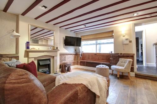 a living room with a couch and a fireplace at Central Two Bed Cottage on Watergate Street in Chester