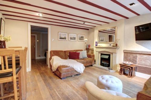 a living room with a couch and a fireplace at Central Two Bed Cottage on Watergate Street in Chester