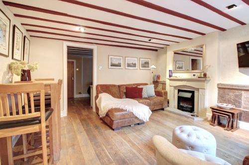 a living room with a couch and a fireplace at Central Two Bed Cottage on Watergate Street in Chester