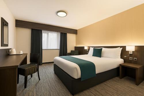 a hotel room with a bed and a desk at Ramada Bristol West in Easton in Gordano