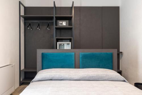 a bedroom with a bed with a blue headboard at Terre del Mandrolisai in Sorgono