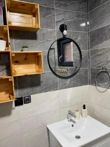 a bathroom with a sink and a mirror on the wall at Brvnara Tarin osmeh - u srcu Nacionalnog parka Tara in Sekulić 