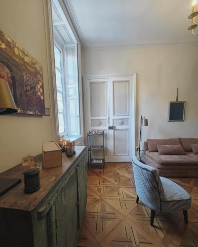 a living room with a couch and a table at Le Royal Dijonnais - Centre Ville in Dijon