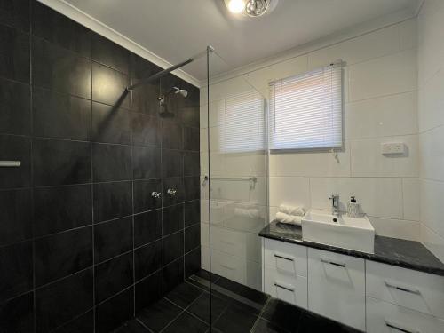 a bathroom with a shower and a sink and a shower at Southern Comfort in Esperance in Esperance