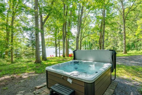 a hot tub sitting in the middle of a forest at Tolson Cabin by Railey Vacations in Oakland