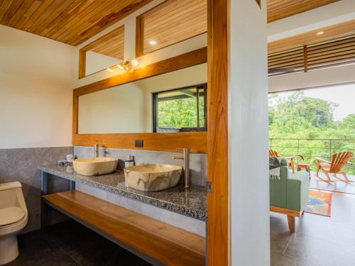 a bathroom with two sinks and a mirror at Southern Drake Lodge in Drake