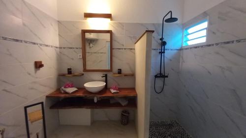 a bathroom with a sink and a mirror at Studio tout confort - Hameka in Grand-Bourg