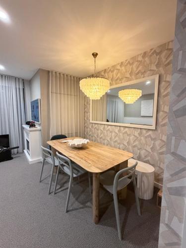a dining room with a wooden table and chairs at 24 Bromley St private room in a luxurious shared apt in Brisbane