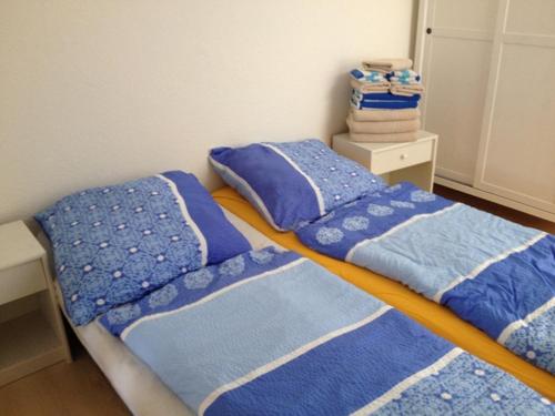 two beds in a room with blue blankets and pillows at Ferienwohnung Fritz in Zinnowitz