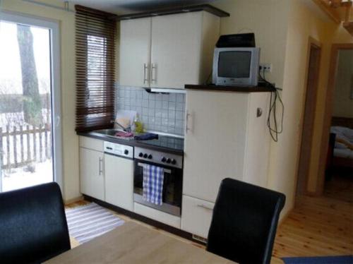 a kitchen with a stove and a tv on top of it at Ferienhaus Fredy in Zinnowitz