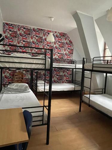 a dorm room with four bunk beds in it at Hostel Universus in Gdańsk