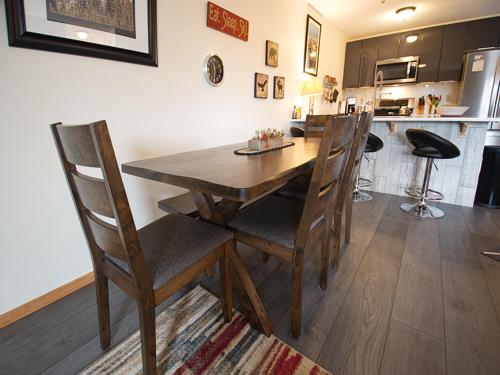 a dining room table with chairs and a kitchen at Silverado I Building B Unit 204 in Winter Park