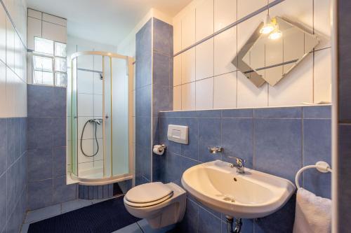 a bathroom with a toilet and a sink and a shower at Apartments Padovan in Rab