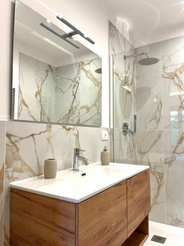 a bathroom with a sink and a shower at Casa Bonomo in Castelbuono