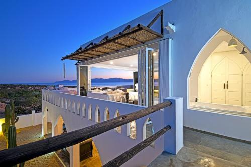 a house with a balcony with a view of the ocean at The Moroccan Palace Entire Villa in El Sargento