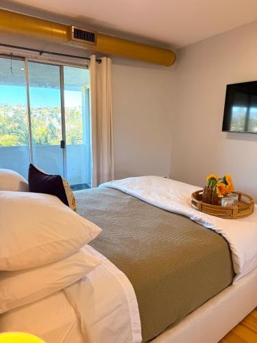 a bedroom with two beds and a flat screen tv at Echo Lake view condo - newly renovated - centrally located in Los Angeles