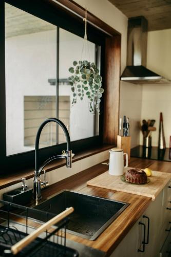 a kitchen with a sink and a counter top at Coração da Quinta in Algarvia