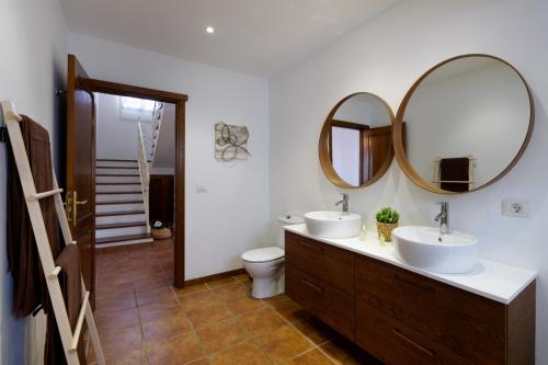 a bathroom with two sinks and a mirror at Villa Europa in Nazaret