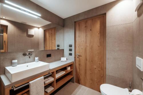 a bathroom with a sink and a mirror at Resciesa Hof in Ortisei