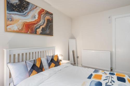 a bedroom with a bed and a painting on the wall at Creel Cottage, Peterhead in Peterhead