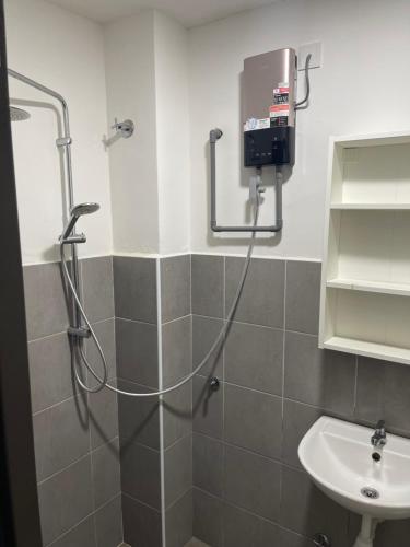 a bathroom with a shower and a sink at Nafisa Homestay in Kepala Batas