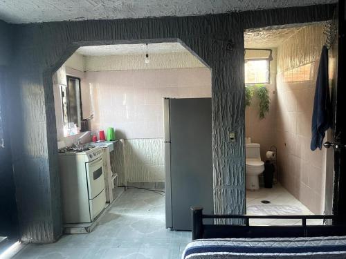 a small kitchen with a sink and a refrigerator at Departamento Central Camionera in Guadalajara