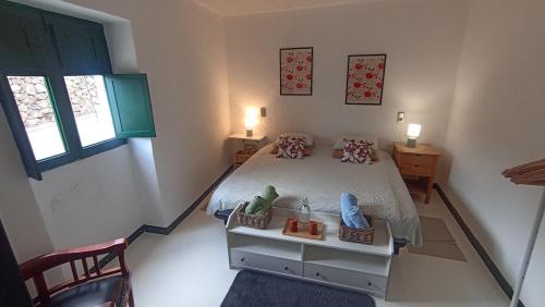 a bedroom with a bed with two shoes on it at Olala House Lanzarote in Haría
