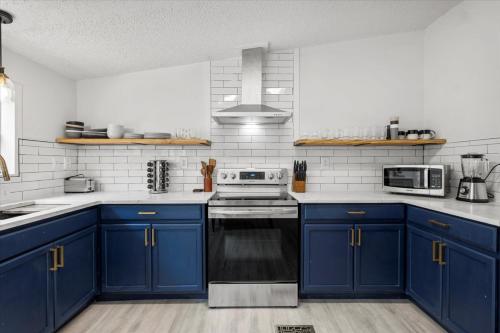 a kitchen with blue cabinets and a stove top oven at Starlight Horizon in Canyon Lake