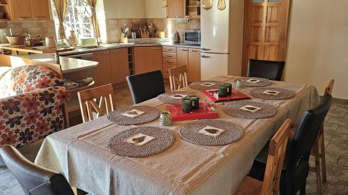 a kitchen with a table with chairs and a kitchen with a tableablish at Srub pod Tetřevím vrchem in Dolni Dvur