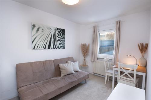 a living room with a couch and a table at Schöne moderne 2-Zimmerwohnung in Göppingen