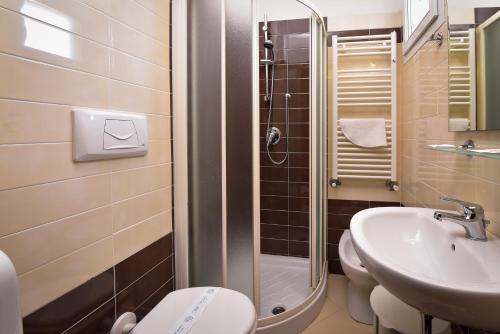 a bathroom with a sink and a toilet and a shower at Nuovo Hotel Diamante in Cesenatico