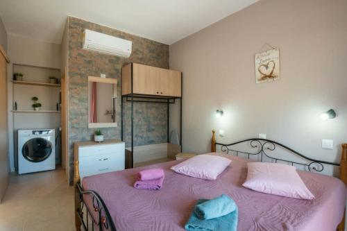 a bedroom with a large pink bed with two pillows at Stergios top view residence with jacuzzi in Kolymbia