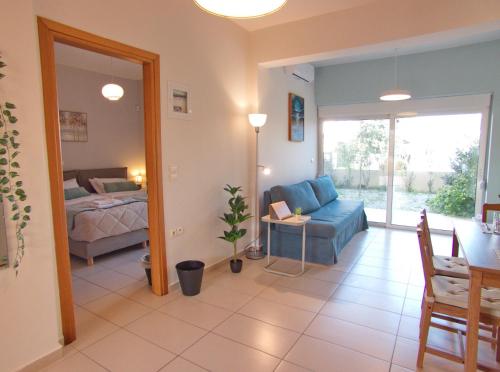 a living room with a bed and a blue couch at Peris #2 - Souda in Souda