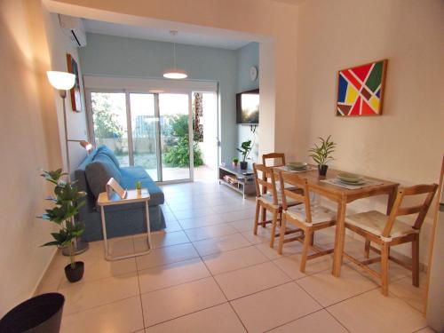 a living room with a table and a blue couch at Peris #2 - Souda in Souda