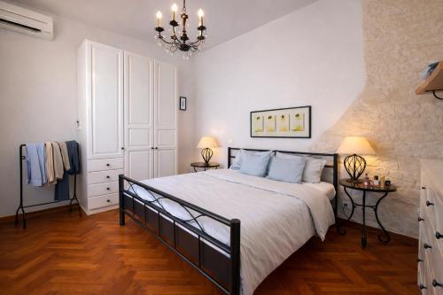 a bedroom with a large bed and two lamps at Beachfront Villa Cannes I Garden - Terrace & Sea View -Prime Location- Free Parking in Cannes