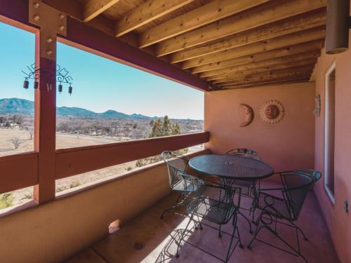 a patio with a table and chairs on a balcony at Cielo Grande 305 in Santa Fe