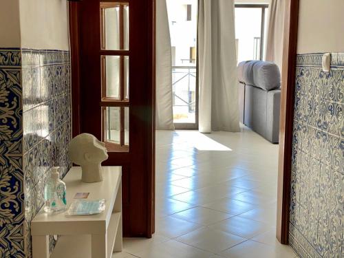 a room with a table with a statue on it at Pure Vilamoura 2 bedrooms with pool in Quarteira