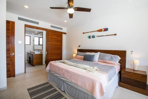 a bedroom with a bed and a ceiling fan at Alamar Vallarta in Cruz de Huanacaxtle