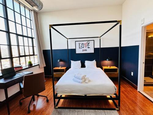 a bedroom with a black and white canopy bed at Sosuite at Independence Lofts - Callowhill in Philadelphia