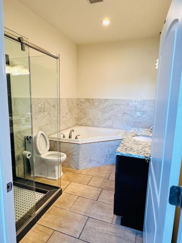 a bathroom with a tub and a toilet and a shower at Sosuite at Independence Lofts - Callowhill in Philadelphia