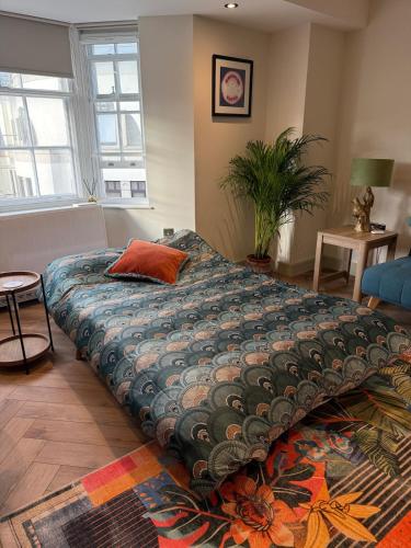 a bedroom with a large bed with a pillow on it at Heart of Brighton Apartment in Brighton & Hove