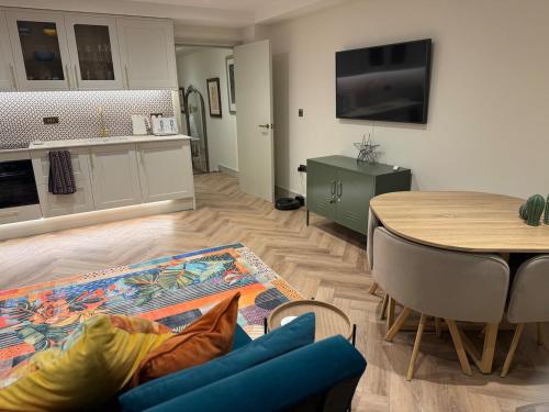 a living room with a table and a dining room at Heart of Brighton Apartment in Brighton & Hove