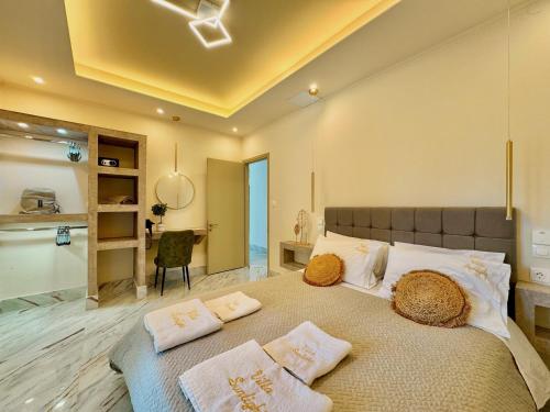 a bedroom with a large bed with pillows on it at Villa Sunlight Sidari with private pool by DadoVillas in Sidari