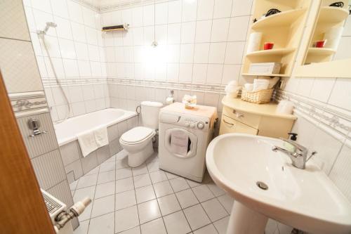 a white bathroom with a toilet and a sink at Apartament Eva in Wrocław